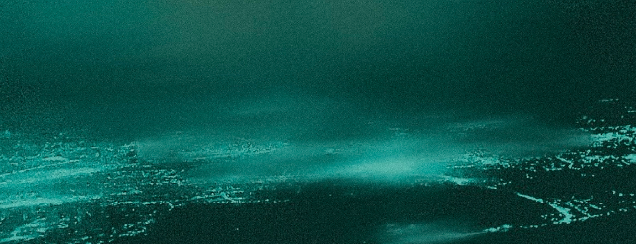 a dark distant landscape in monochrome azure